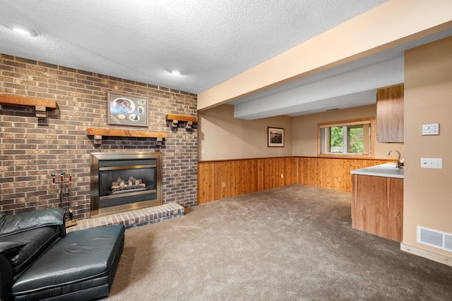 2520 Florida Ave N, Golden Valley, MN 55427 - carpeted living room with wooden walls, a wainscoted wall, a textured ceiling, and a brick fireplace