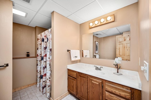 2520 Florida Ave N, Golden Valley, MN 55427 - bathroom with a drop ceiling, vanity, a shower with curtain, and tile patterned floors