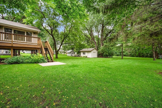 2520 Florida Ave N, Golden Valley, MN 55427 - view of green lawn featuring stairs, a deck, a shed, view of wooded area, and a detached garage