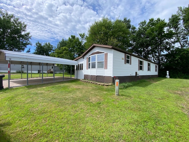 225 Jay St Unit 12, Sandstone, MN 55072 - view of home's exterior with a carport and a yard