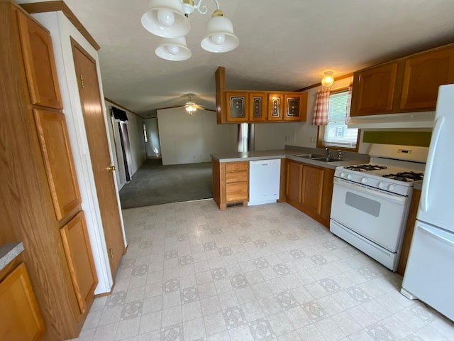 225 Jay St Unit 12, Sandstone, MN 55072 - kitchen with white appliances, light floors, a peninsula, under cabinet range hood, and brown cabinets