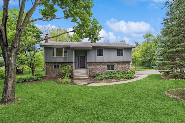 551 Townes Rd, Minnetonka, MN 55391 - bi-level home with a chimney, brick siding, a front yard, and driveway