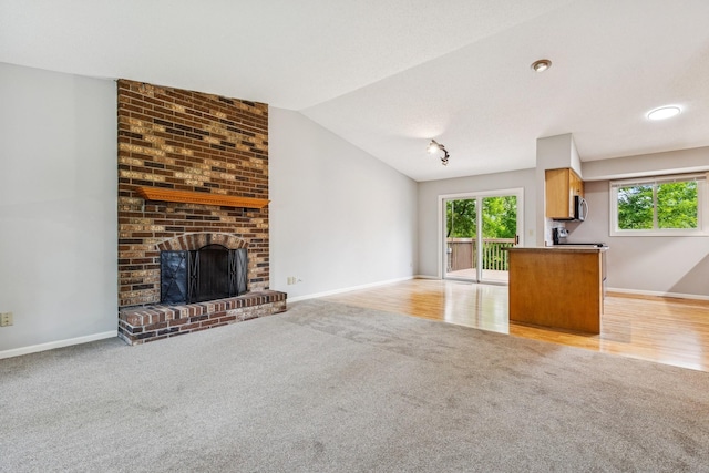 551 Townes Rd, Minnetonka, MN 55391 - unfurnished living room featuring light colored carpet, a brick fireplace, and lofted ceiling