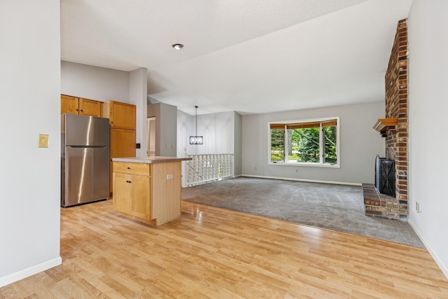 551 Townes Rd, Minnetonka, MN 55391 - kitchen with freestanding refrigerator, light wood-type flooring, open floor plan, and a center island