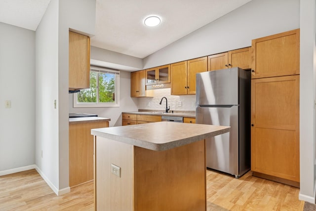 551 Townes Rd, Minnetonka, MN 55391 - kitchen featuring appliances with stainless steel finishes, backsplash, light wood-type flooring, vaulted ceiling, and glass insert cabinets