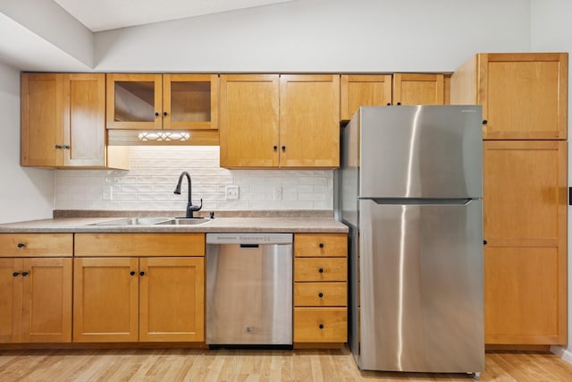 551 Townes Rd, Minnetonka, MN 55391 - kitchen featuring appliances with stainless steel finishes, backsplash, light wood-style flooring, lofted ceiling, and glass insert cabinets