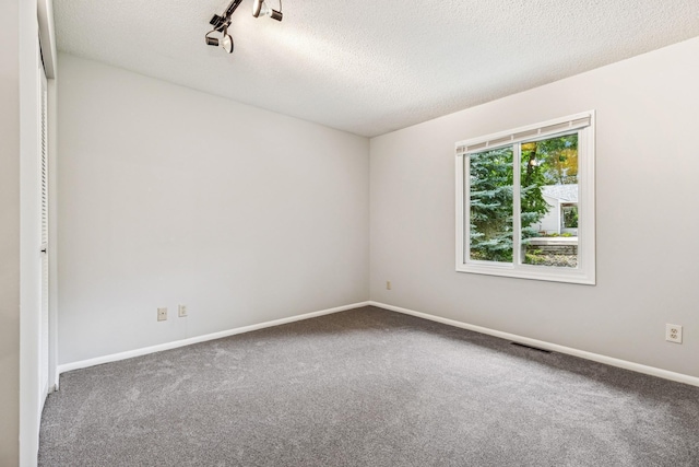 551 Townes Rd, Minnetonka, MN 55391 - carpeted spare room with a textured ceiling and baseboards