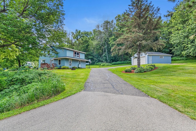 1273 County Rd N, Kinnickinnic Twp, WI 54023 - view of front of property with an outbuilding, asphalt driveway, a front lawn, and a garage