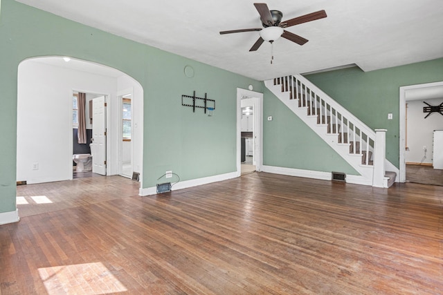 1273 County Rd N, Kinnickinnic Twp, WI 54023 - unfurnished living room with ceiling fan, arched walkways, and wood finished floors