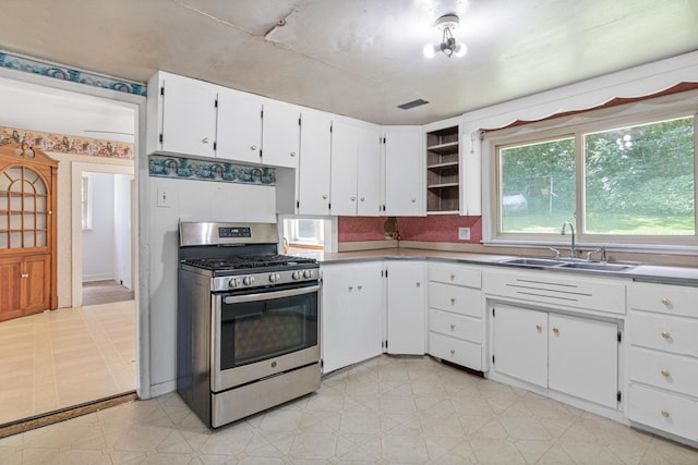 1273 County Rd N, Kinnickinnic Twp, WI 54023 - kitchen featuring stainless steel gas range oven, white cabinets, light floors, open shelves, and light countertops