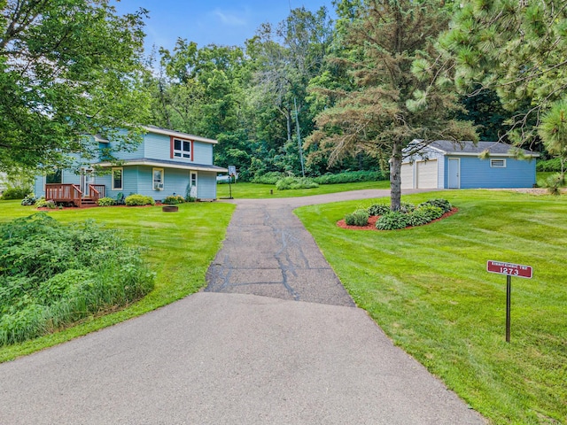 1273 County Rd N, Kinnickinnic Twp, WI 54023 - view of front of home with an outbuilding, asphalt driveway, a front yard, and a wooden deck