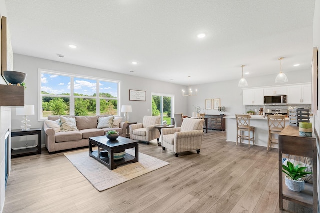 2452 Greenbriar Ln, Buffalo, MN 55313 - living room with light wood-style floors, a chandelier, and recessed lighting