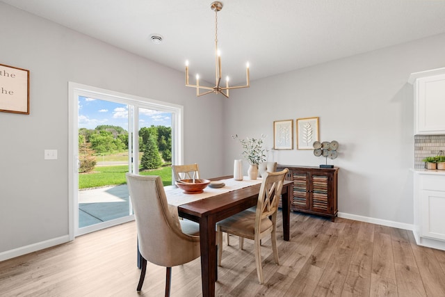 2452 Greenbriar Ln, Buffalo, MN 55313 - dining space featuring a chandelier and light wood-style flooring