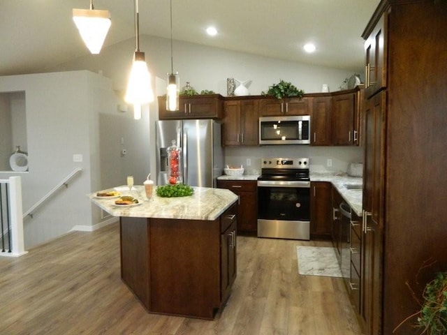 2109 6th Ave NE, Kasson, MN 55944 - kitchen with appliances with stainless steel finishes, lofted ceiling, light wood-type flooring, a center island, and hanging light fixtures