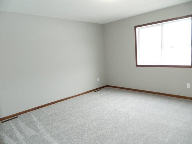 2109 6th Ave NE, Kasson, MN 55944 - spare room featuring light colored carpet and baseboards