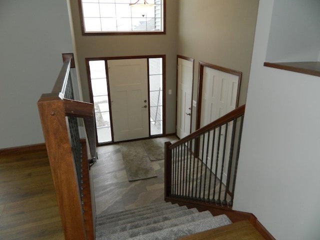 2109 6th Ave NE, Kasson, MN 55944 - foyer featuring stairs, a towering ceiling, plenty of natural light, and wood finished floors