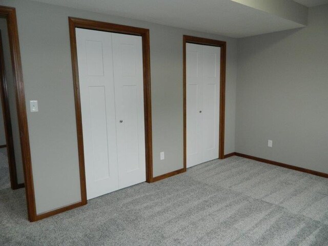 2109 6th Ave NE, Kasson, MN 55944 - unfurnished bedroom with carpet flooring and multiple closets