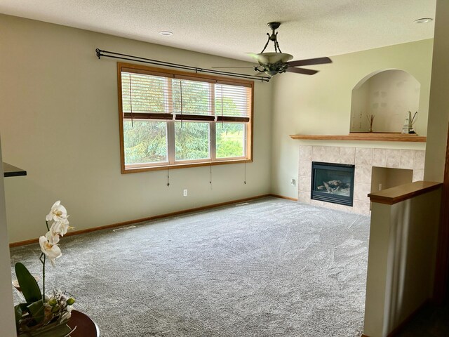 7263 Falmouth Curv, Shakopee, MN 55379 - unfurnished living room with carpet, a tile fireplace, a textured ceiling, and ceiling fan