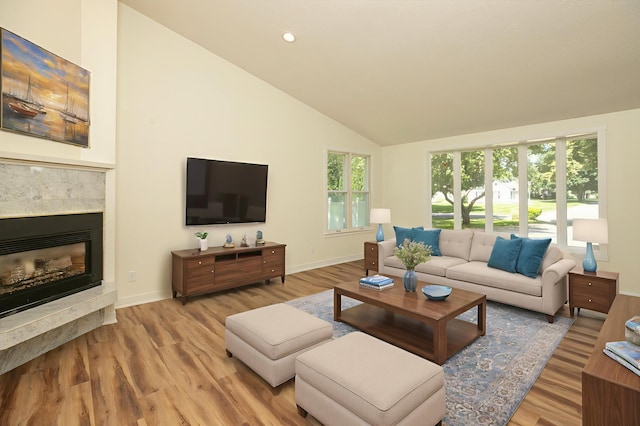 405 River St SW, Chatfield, MN 55923 - living room with wood finished floors, a premium fireplace, high vaulted ceiling, and recessed lighting
