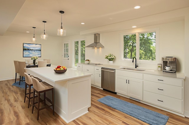 405 River St SW, Chatfield, MN 55923 - kitchen featuring a breakfast bar area, wall chimney exhaust hood, white cabinets, stainless steel dishwasher, and a kitchen island