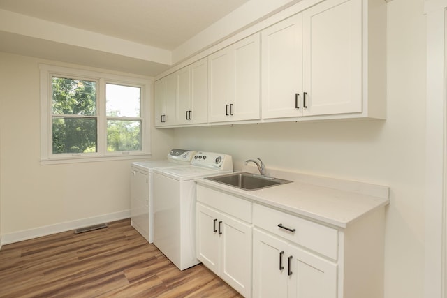 405 River St SW, Chatfield, MN 55923 - laundry area with cabinet space, washing machine and clothes dryer, and light wood-style floors
