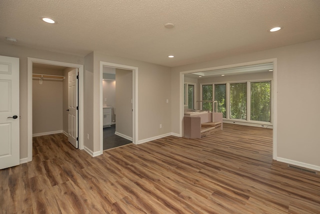 405 River St SW, Chatfield, MN 55923 - unfurnished living room featuring wood finished floors, a textured ceiling, and recessed lighting