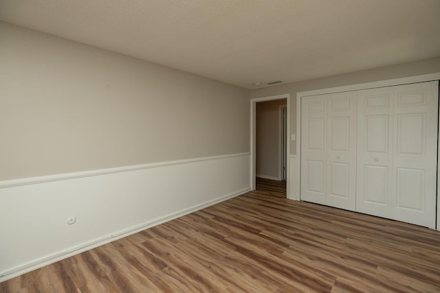 405 River St SW, Chatfield, MN 55923 - unfurnished bedroom with wood finished floors and a closet