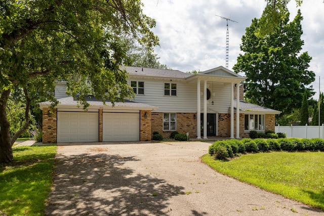 405 River St SW, Chatfield, MN 55923 - neoclassical home featuring brick siding, concrete driveway, and an attached garage