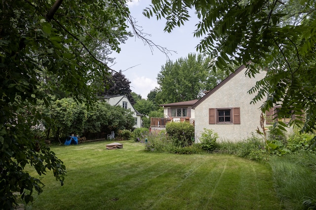 3979 Reservoir Blvd, Columbia Heights, MN 55421 - view of grassy yard with a fire pit and a deck