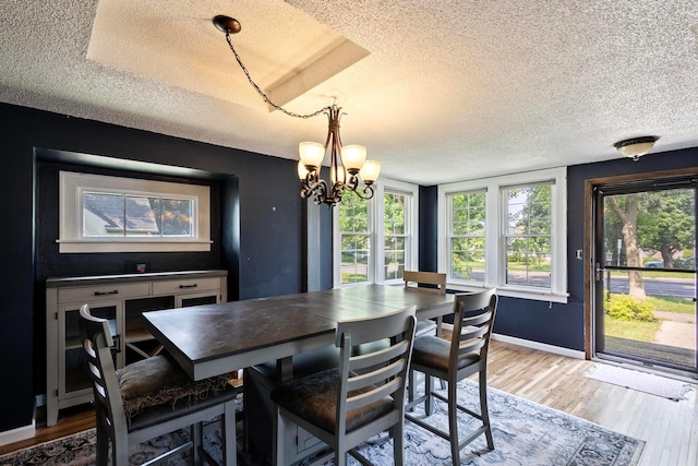 3979 Reservoir Blvd, Columbia Heights, MN 55421 - dining room with a textured ceiling, a chandelier, and light wood-type flooring