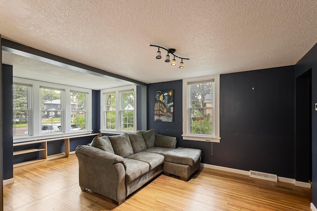 3979 Reservoir Blvd, Columbia Heights, MN 55421 - living area featuring wood finished floors, a textured ceiling, and plenty of natural light