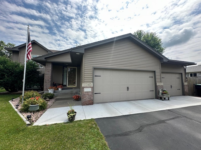 12313 Ilex St NW, Coon Rapids, MN 55448 - single story home featuring brick siding, a garage, driveway, and covered porch