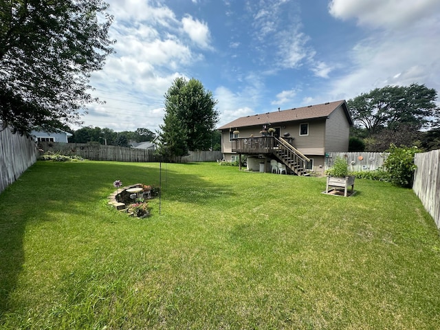12313 Ilex St NW, Coon Rapids, MN 55448 - fenced backyard featuring a fire pit, a deck, and stairway