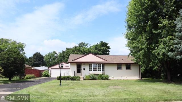 6007 Vincent Ave N, Brooklyn Center, MN 55430 - ranch-style home with a front lawn, a garage, and stucco siding