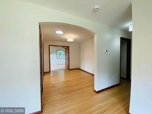 6007 Vincent Ave N, Brooklyn Center, MN 55430 - hallway with arched walkways and light wood finished floors