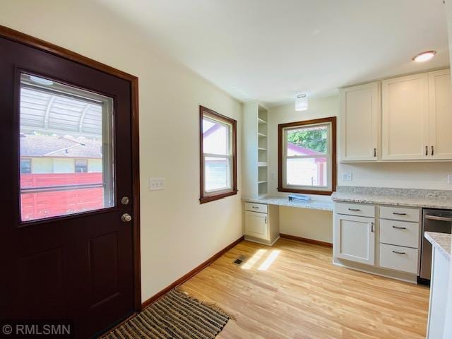 6007 Vincent Ave N, Brooklyn Center, MN 55430 - kitchen with stainless steel dishwasher, light wood finished floors, and white cabinets