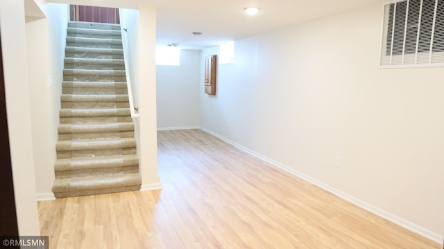 6007 Vincent Ave N, Brooklyn Center, MN 55430 - stairway featuring wood finished floors and baseboards