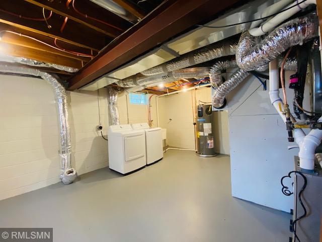 6007 Vincent Ave N, Brooklyn Center, MN 55430 - unfinished basement featuring electric water heater, washer and dryer, and heating unit