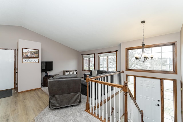3415 Lake St NW, Rochester, MN 55901 - living room with a chandelier, light wood-style floors, and lofted ceiling
