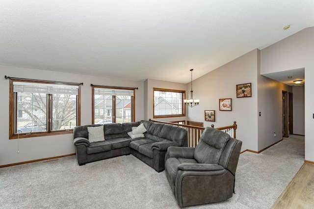3415 Lake St NW, Rochester, MN 55901 - living room with a chandelier, vaulted ceiling, light wood-type flooring, and light colored carpet