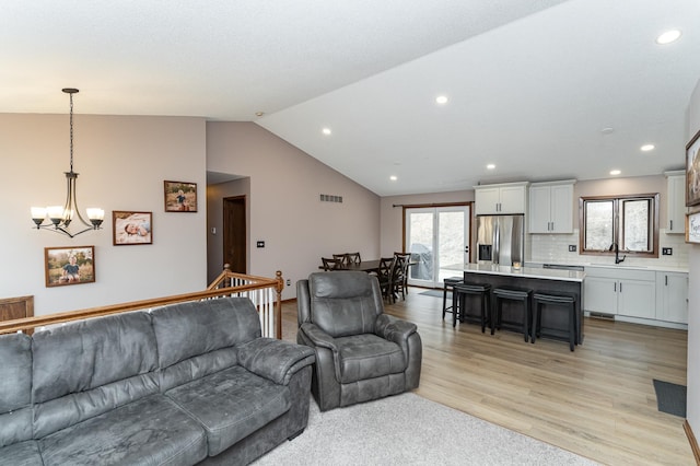 3415 Lake St NW, Rochester, MN 55901 - living room with a chandelier, lofted ceiling, light wood-style floors, and recessed lighting