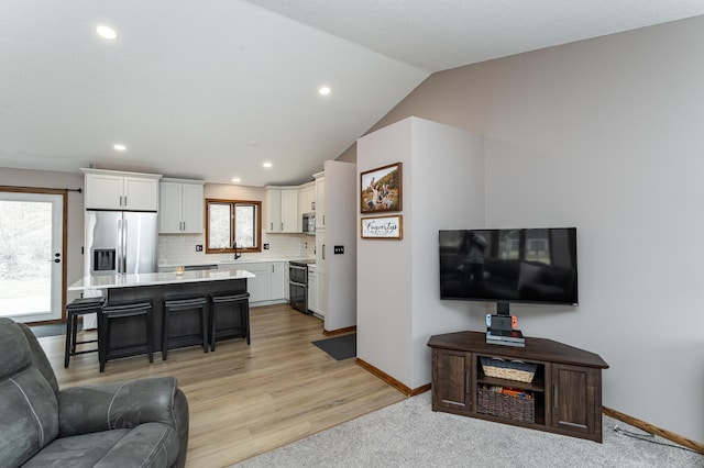 3415 Lake St NW, Rochester, MN 55901 - living area with recessed lighting, light wood finished floors, and vaulted ceiling