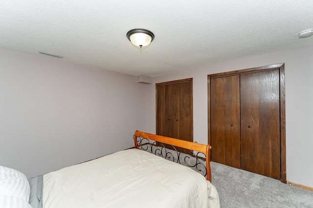 3415 Lake St NW, Rochester, MN 55901 - bedroom with carpet flooring, multiple closets, and a textured ceiling