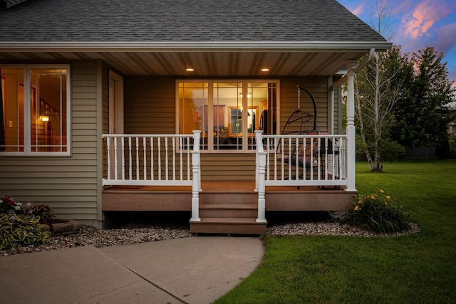 133 Uriah Ct, Mankato, MN 56001 - view of exterior entry with covered porch, roof with shingles, and a yard
