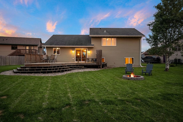 133 Uriah Ct, Mankato, MN 56001 - back of house featuring a fire pit, a wooden deck, and a lawn