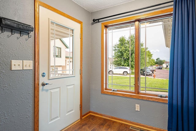 133 Uriah Ct, Mankato, MN 56001 - doorway featuring dark wood-style floors and a textured wall