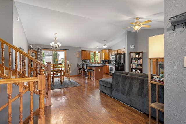 133 Uriah Ct, Mankato, MN 56001 - living room with vaulted ceiling, a chandelier, dark wood-type flooring, a ceiling fan, and stairs