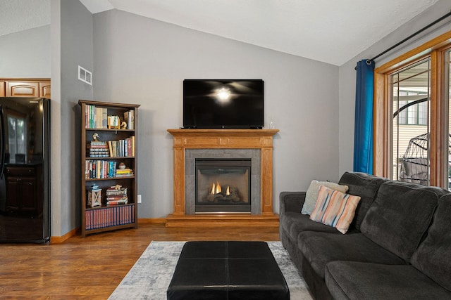 133 Uriah Ct, Mankato, MN 56001 - living room with vaulted ceiling, wood finished floors, and a lit fireplace