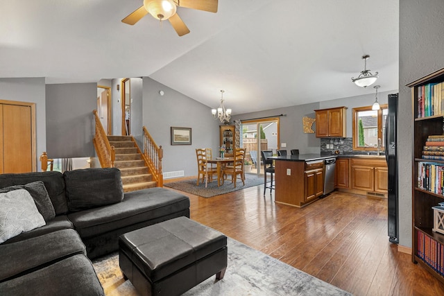 133 Uriah Ct, Mankato, MN 56001 - living area with wood finished floors, ceiling fan, a chandelier, stairway, and lofted ceiling