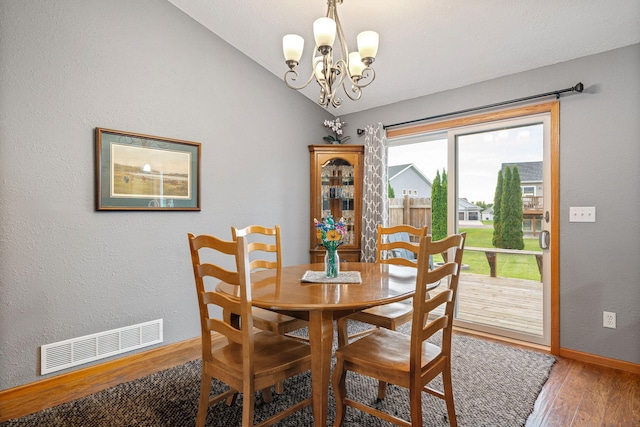 133 Uriah Ct, Mankato, MN 56001 - dining area featuring wood finished floors, vaulted ceiling, and a chandelier